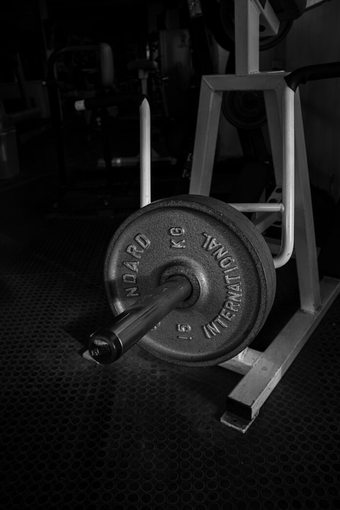Photo by Malik Shibly black and gray dumbbell on black textile