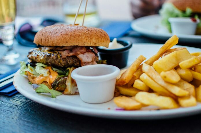 Photo by Robin Stickel selective focus photography of burger patty, mayonnaise, and French fries served on platter