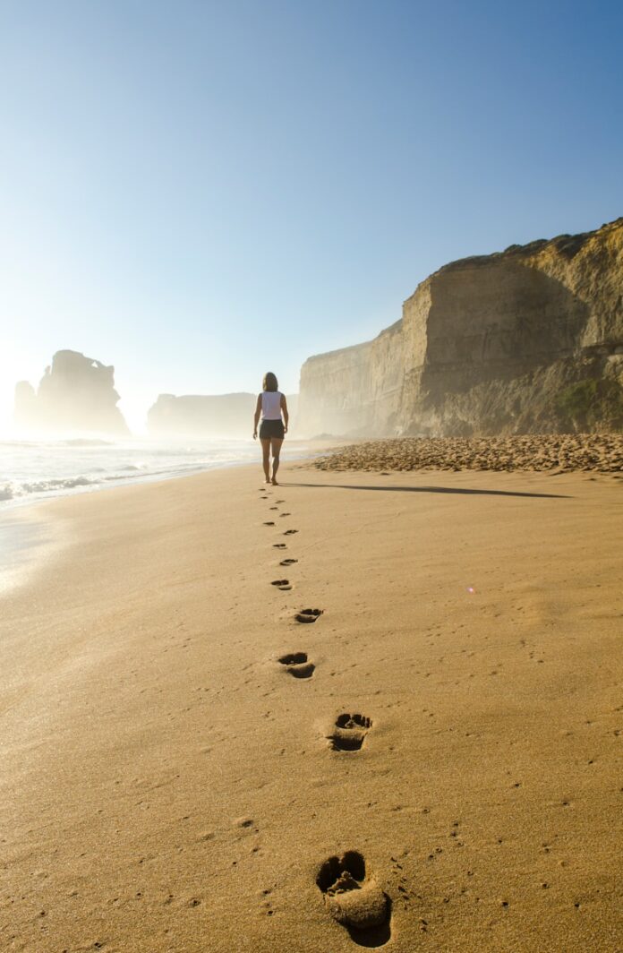 Photo by Brian Mann woman walking on shore