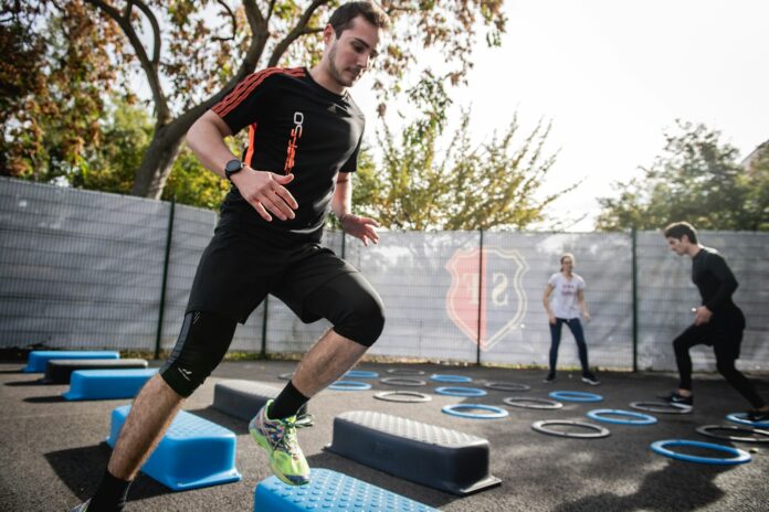 Photo by Gabin Vallet man in black crew neck t-shirt and black shorts running on blue and white trampoline