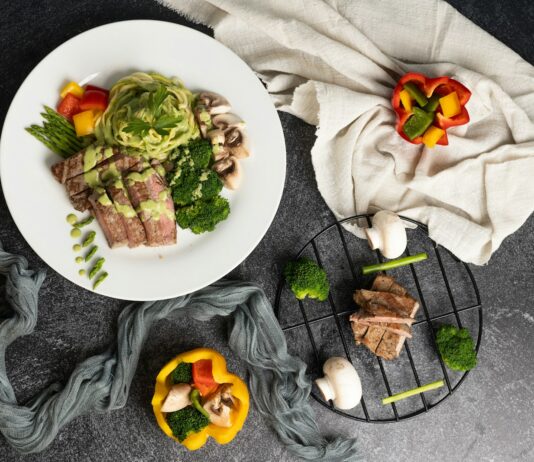 건강을 지키는 첫걸음, 올바른 식단의 중요성 a white plate topped with meat and veggies