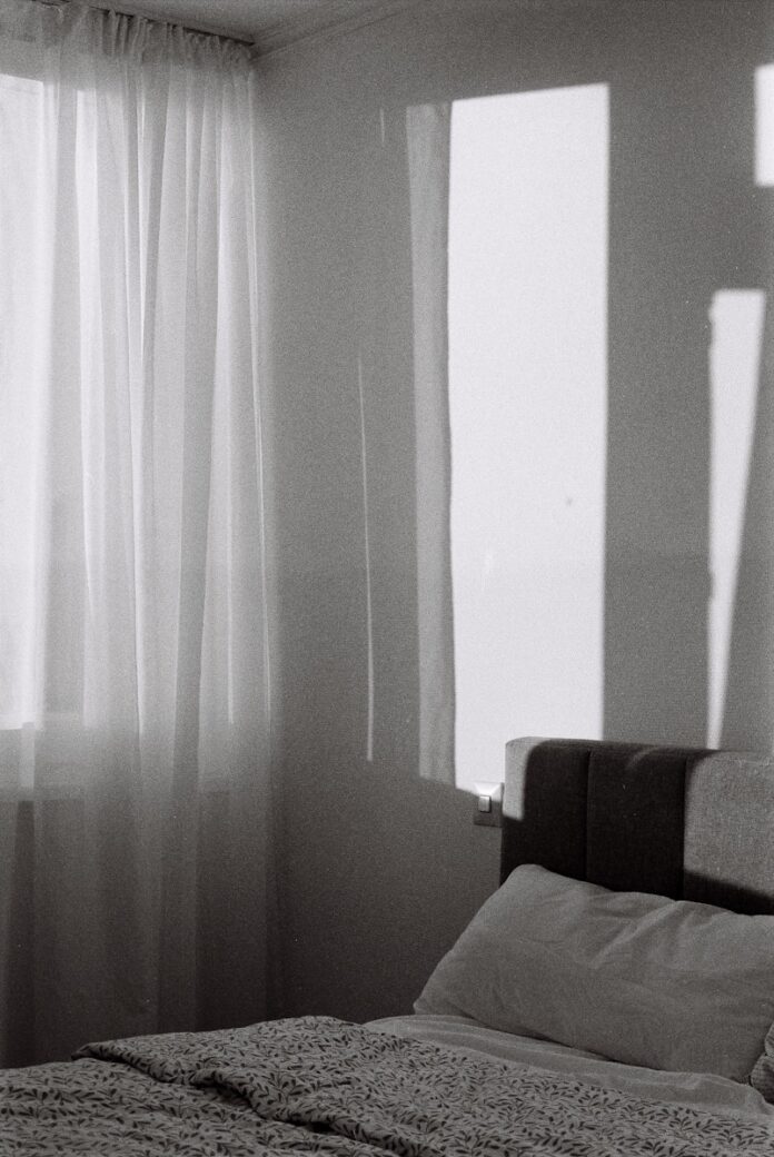 Photo by Ari Shojaei A bed sitting in a bedroom next to a window
