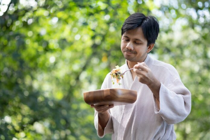 a man holding a plate of food in his hands