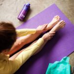 필라테스, 건강과 마음을 모두 챙기는 생활 습관으로 자리잡다 woman in yellow pants lying on purple textile