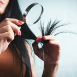 건강한 모발, 생활 속 작은 변화가 열쇠 Woman examining split ends of hair with magnifying glass