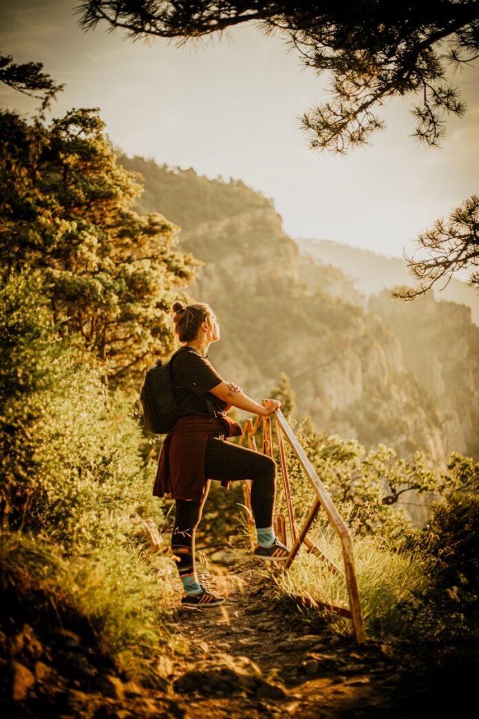 Photo by Nikita Sinyaev man in black long sleeve shirt sitting on brown wooden ladder during daytime
