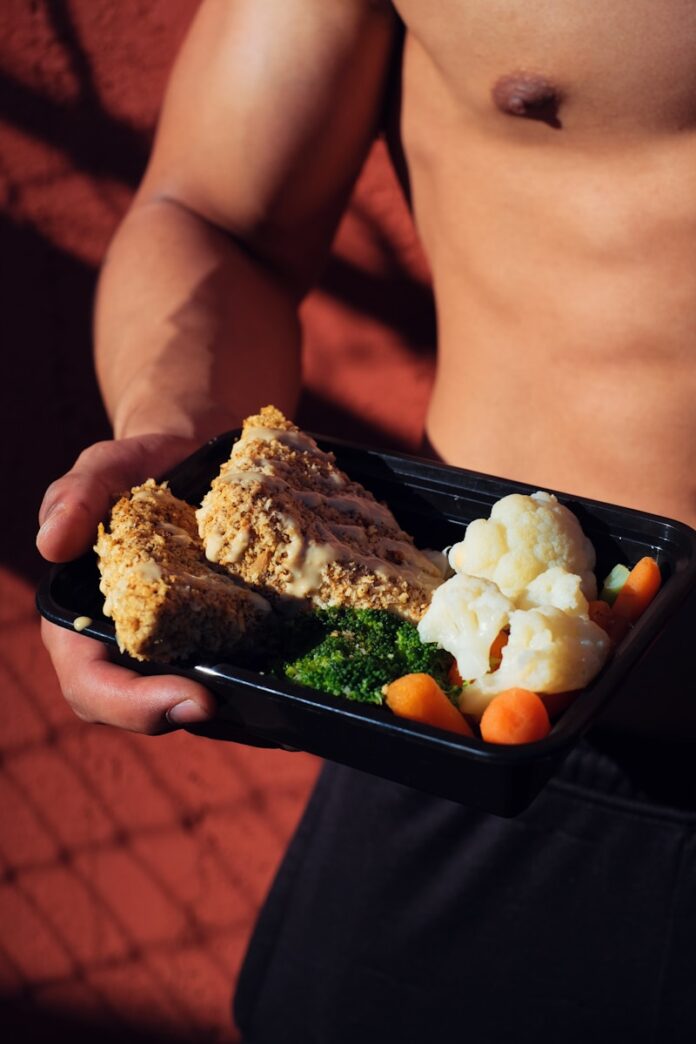 Photo by Mike Von person holding cooked food on black tray